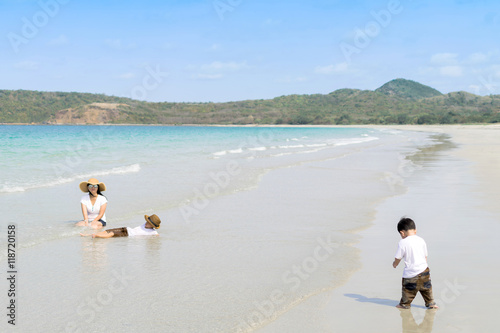 mother and sons playing on beach © aedkafl