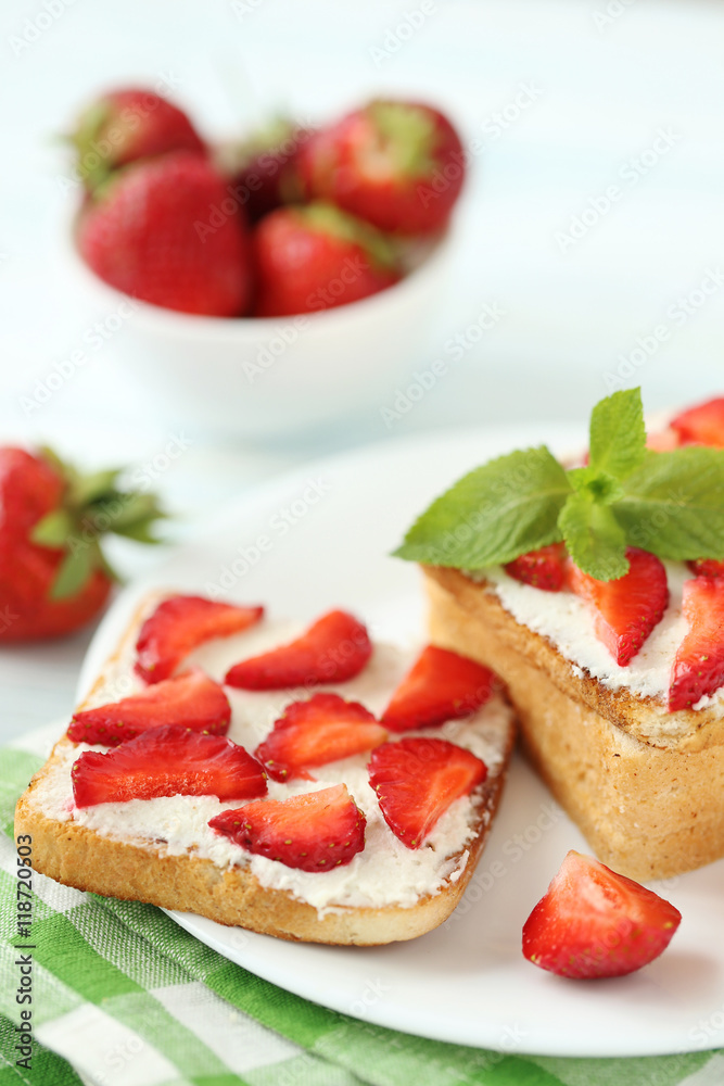 French toasts with cream cheese and strawberry on wooden table French toasts with cream cheese and strawberry on wooden table
