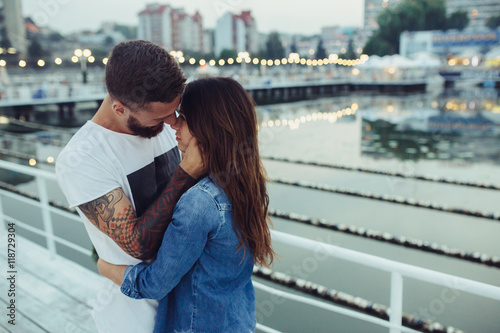 couple posing against the backdrop of the city © teksomolika