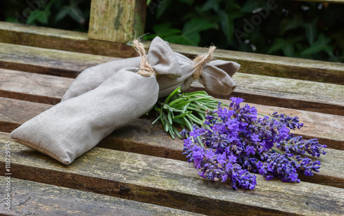 Fototapeta Naklejka Na Ścianę i Meble -  Fresh lavender flowers and lavender bags on rustic wood.