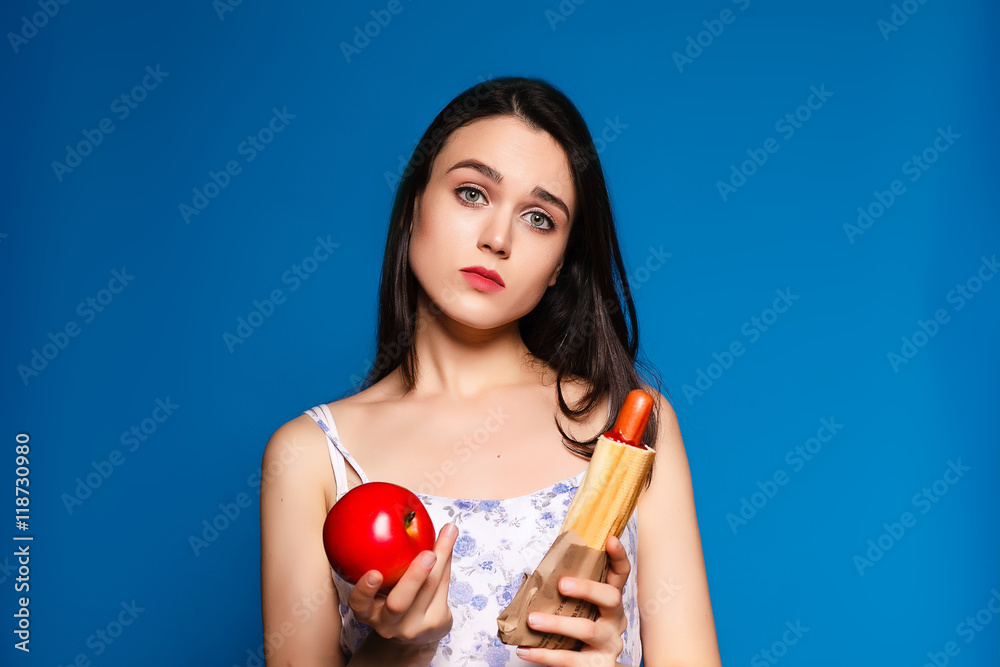 difficult choice of food, a beautiful brunette with a meal on a difficult choice of food, a beautiful brunette with a meal on a