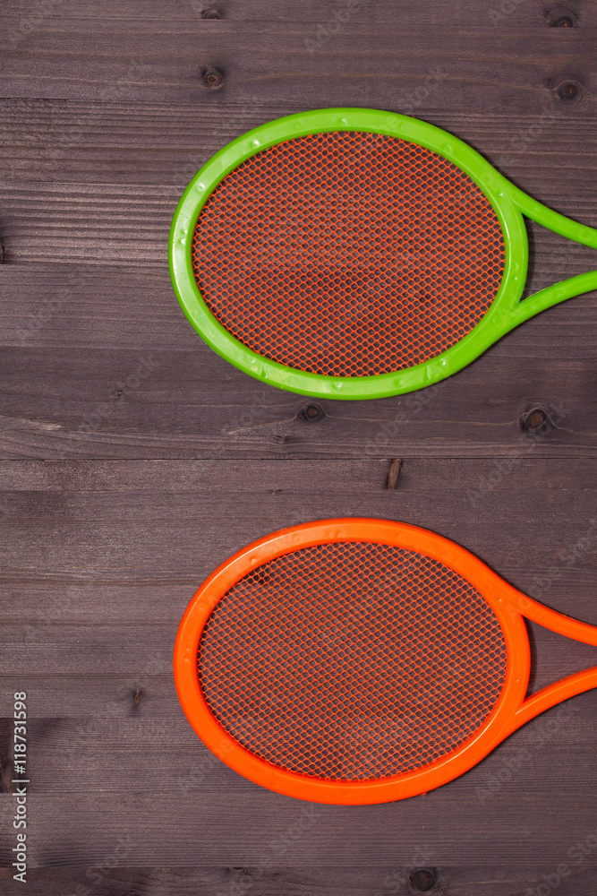 two children's tennis shoes on a wooden board