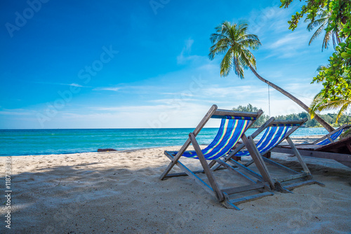 Beautiful tropical island beach with chairs - Travel summer vacation concept.