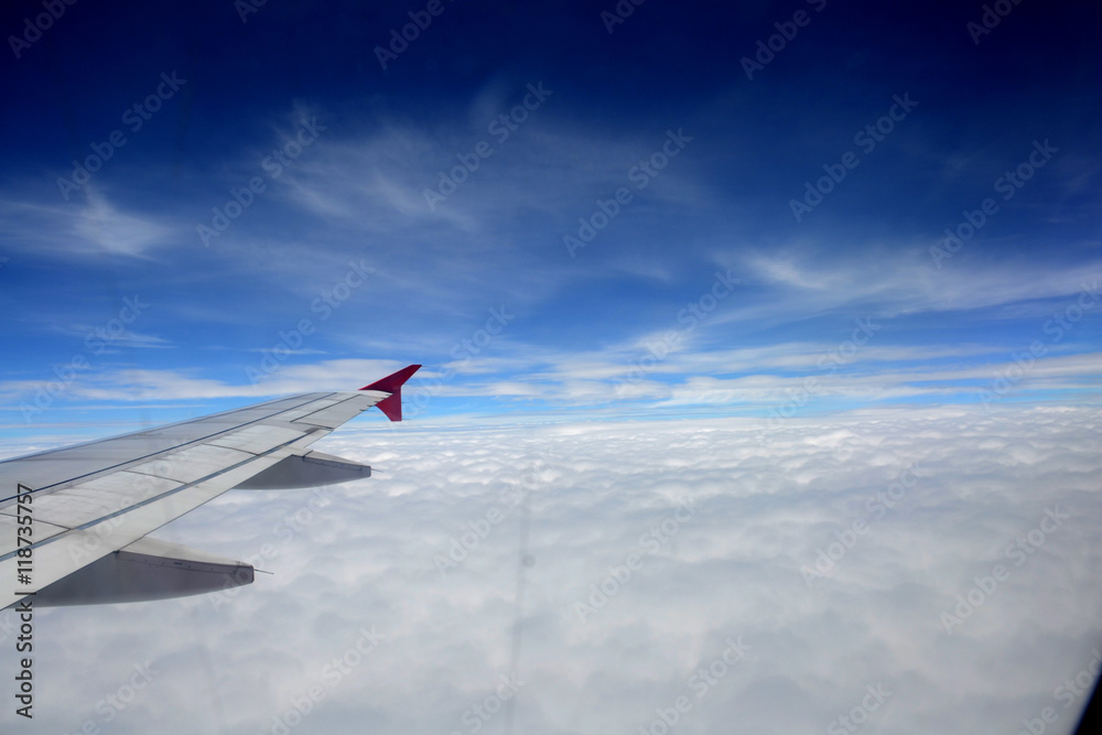 Fototapeta premium window of jet plane with blue sky and city view
