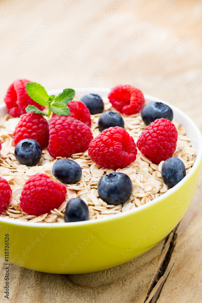Oatmeal porridge with berries. Raspberries and blueberries. Oatmeal porridge with berries. Raspberries and blueberries.