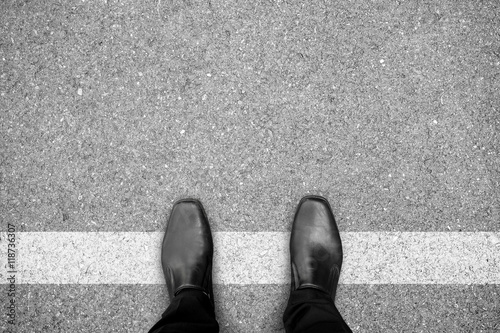 Foto Black shoes standing on white line