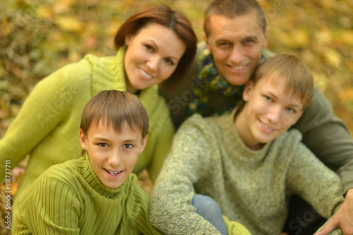 Happy family in autumn forest