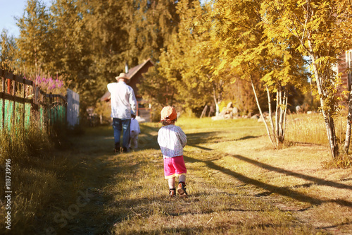 kids walk with grandfather in summer