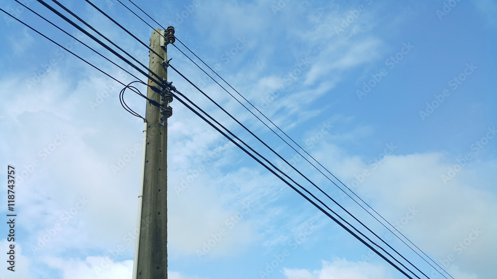 Fototapeta premium electrical high tension lines against blue sky