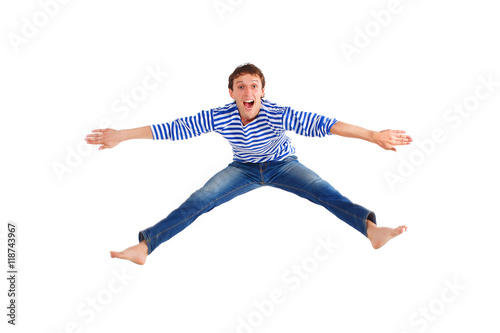 funny guy jumped up isolated on white. cheerful young man jumping. man dressed in a striped sweater and jeans. isolated on white background