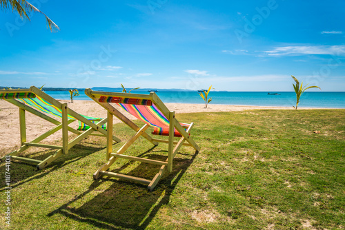 Colorful beach chair on beautiful tropical island beach summer holiday - Travel vacation concept.	