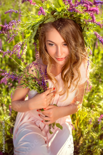 Portrait of a dreamy lady in a luxurious wreath of wildflowers © kharchenkoirina