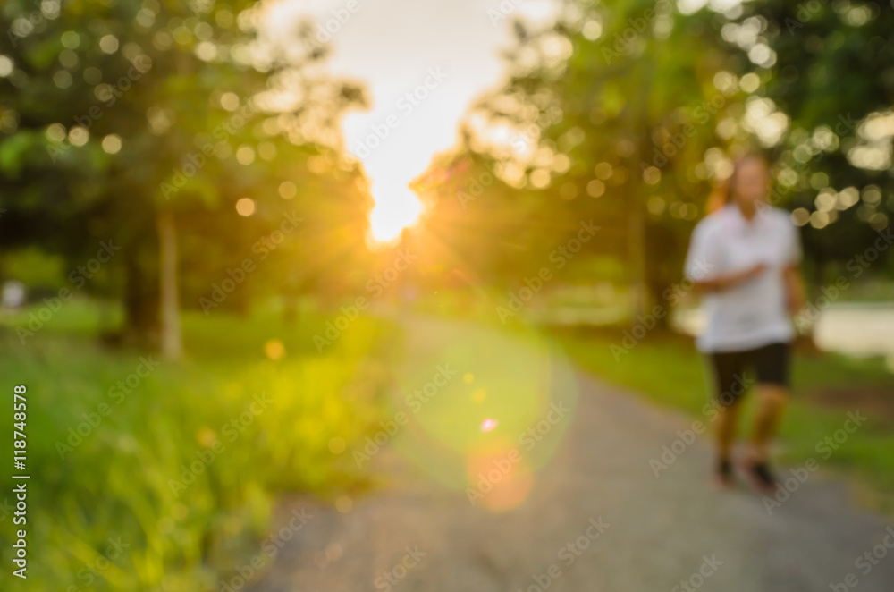 Blurred park, natural background and people runing walking