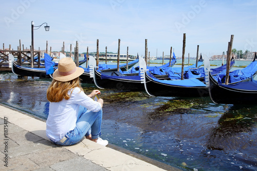Tourist woman on vacation exploring (Venice) old town in Italy © sepy