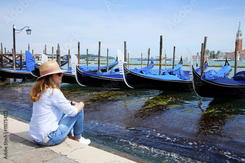 Tourist woman on vacation exploring (Venice) old town in Italy © sepy
