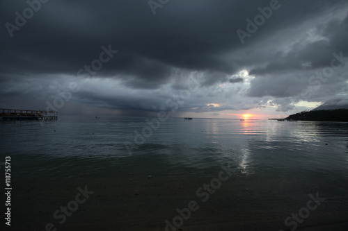 beautiful asian cloudy sunset over the ocean with bridge silhouettes photo