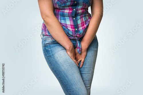 Woman with hands holding her crotch, she wants to pee
