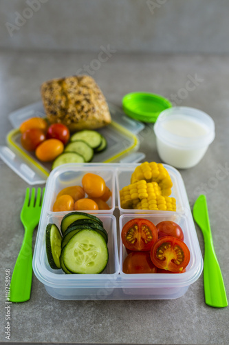 Healthy vegetarian food in plastic lunch box on light background. 