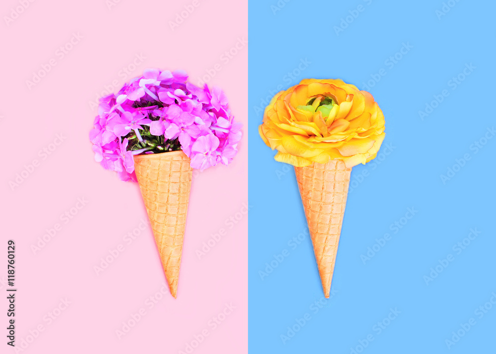 Two ice cream cone with flowers over colorful pink blue backgrou Two ice cream cone with flowers over colorful pink blue backgrou