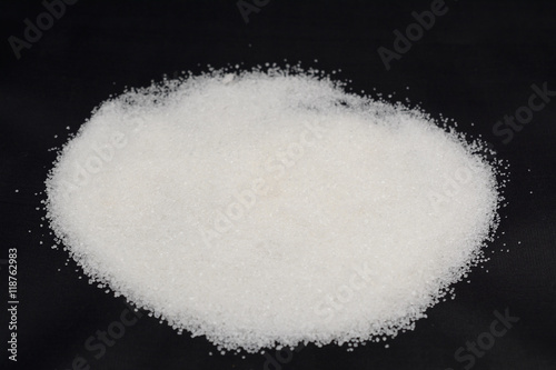 granulated sugar on a black background
