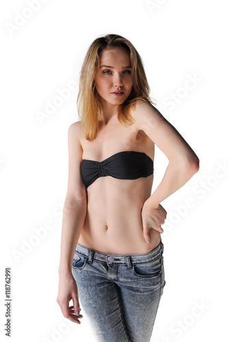 Pretty young blonde in black colored bra and jeans