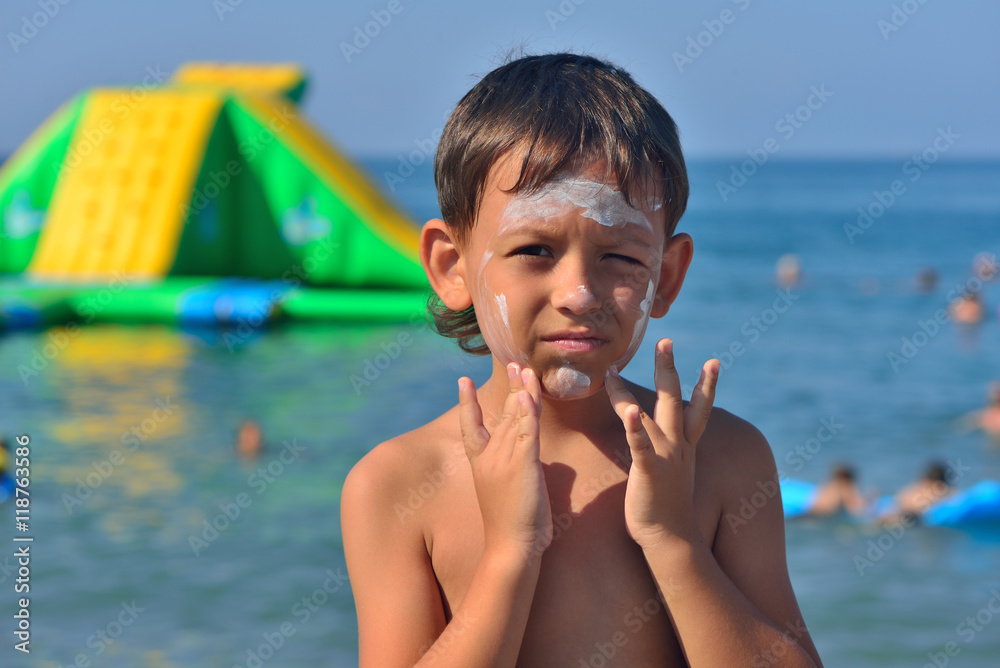 Boy does sunscreen on face Stock Photo Adobe Stock