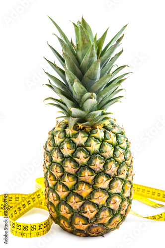 Obraz na plátně Pineapple with measuring tape isolated over white.