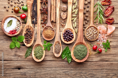 Fototapeta Naklejka Na Ścianę i Meble -  Spices with fresh herbs on a wooden background