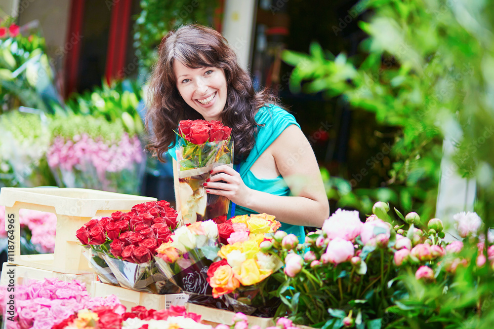 French woman choosing flowers on market