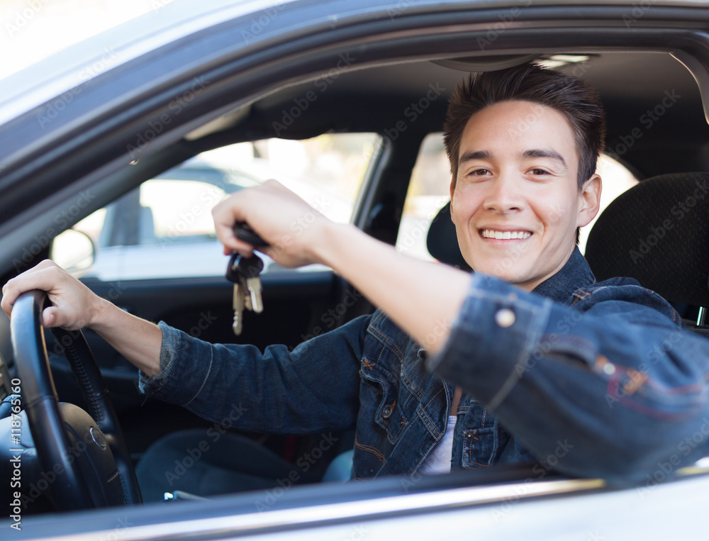 Obraz premium Handsome male driver holding a pair of car keys.