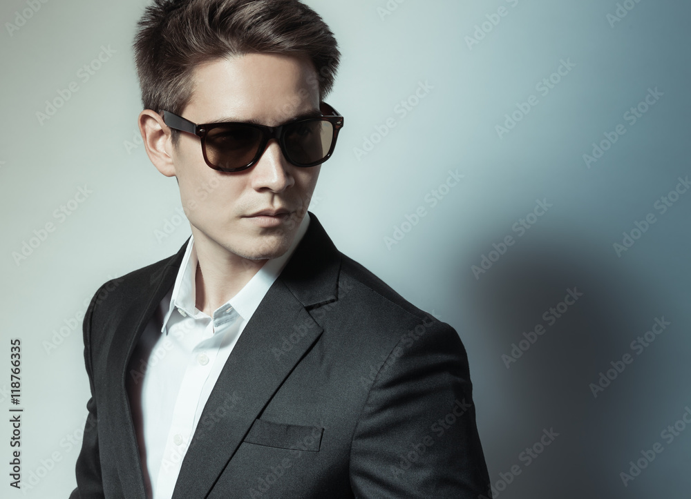Handsome male fashion model in suit and sunglasses. Handsome male fashion model in suit and sunglasses.