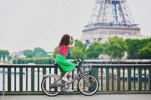 Woman riding a bicycle on a street of Paris