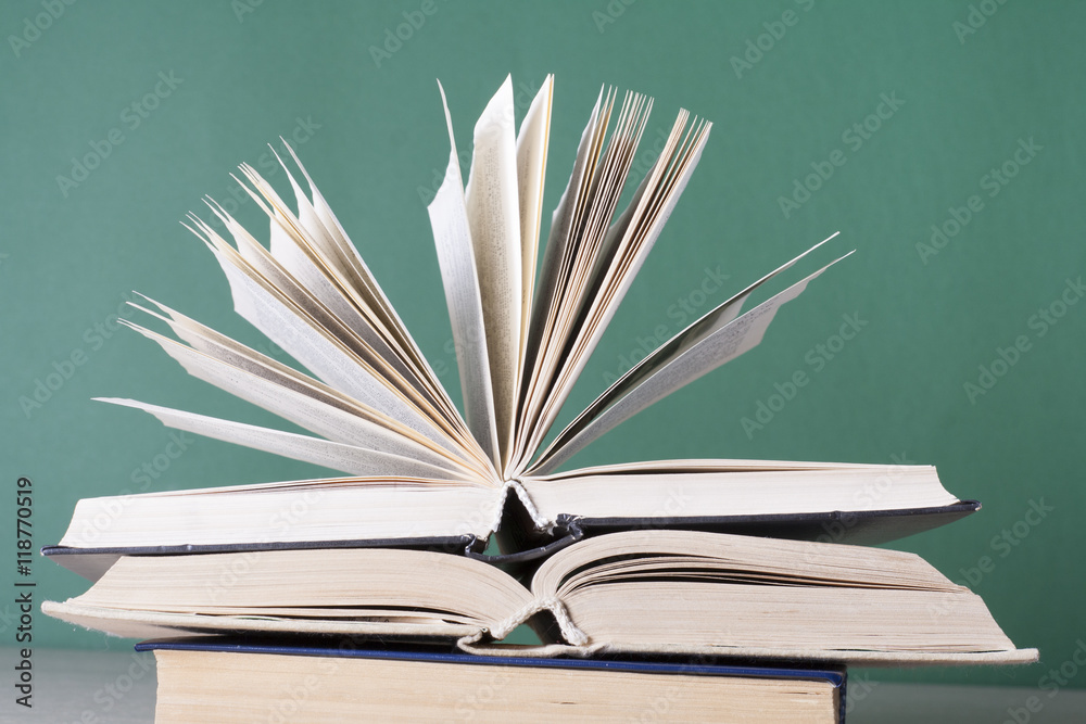 Fototapeta premium Open book, hardback books on wooden table. Education background. Back to school. Copy space for text.