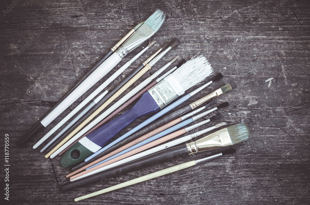Paint brushes on wooden table