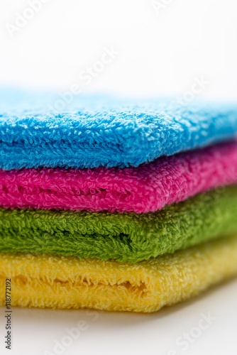 colorful  stacked bathroom towels  isolated on a white background  close up  vertical