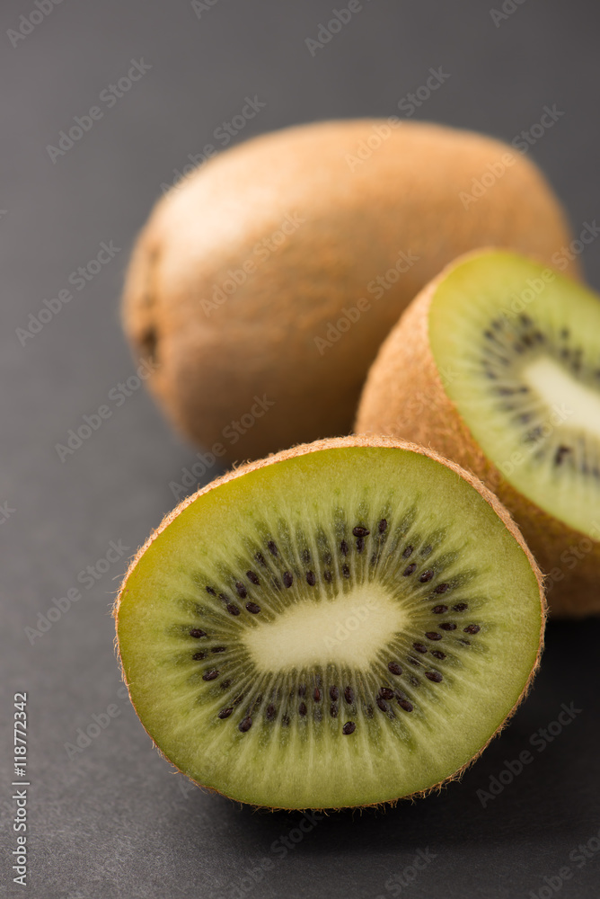 fresh cut kiwi fruit isolated on black background, close up, vertical fresh cut kiwi fruit isolated on black background, close up, vertical
