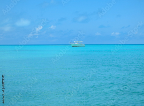 Small yacht anchored in the blue water off the coast of Bermuda