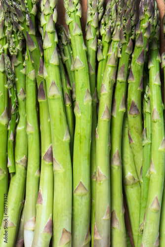 bunch of asparagus stems as food background, vertical, close up
