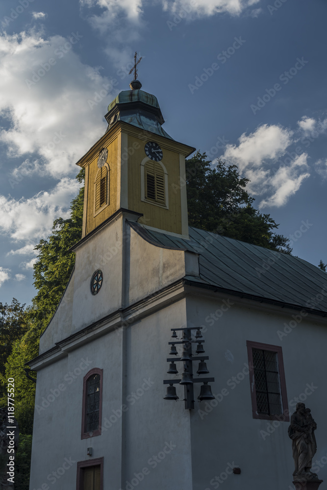 Church with tower and cross in Krkonose mountains