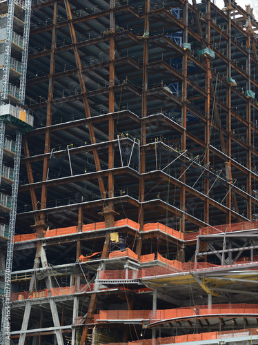 Construction site of new commercial building with skeleton buildings with steel girders and cement frame