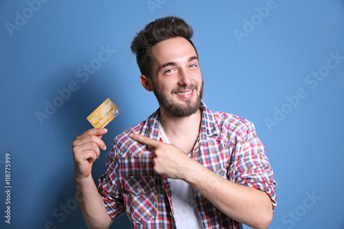 Young man holding credit ca...