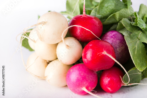 bunch of organically grown, freshly harvested, colorful Easter egg radishes, isolated over white board, close up, horizontal