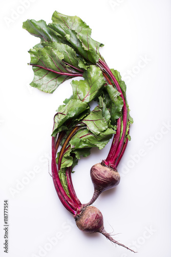 whole beetroots with green leaves, isolated on a white background, top view, vertical