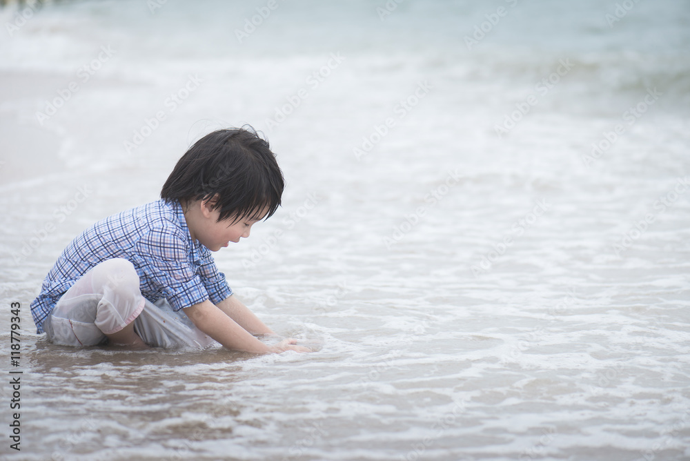 asian boy playing on the beach asian boy playing on the beach