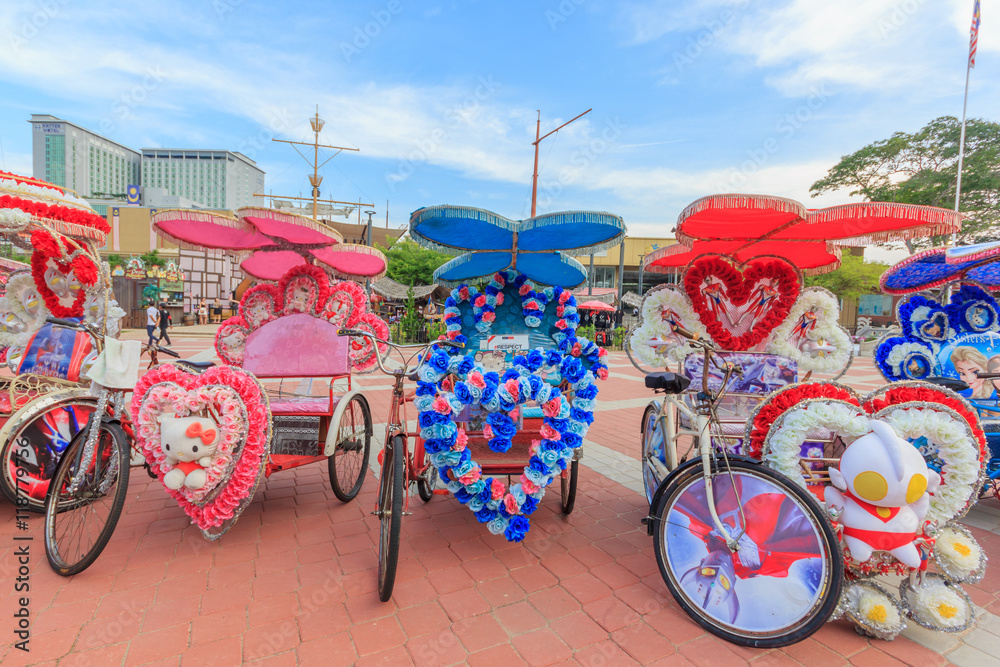 The decorated trishaw parking in a Famosa Castle in Malacca,tourists and local people can seen around the Famosa Castle in Malacca