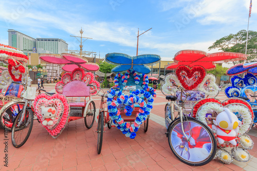 The decorated trishaw parking in a Famosa Castle in Malacca,tourists and local people can seen around the Famosa Castle in Malacca photo