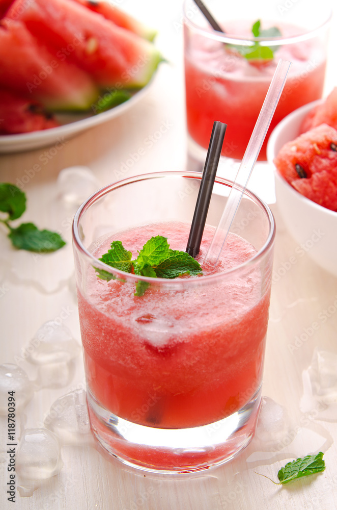 Healthy watermelon smoothie with mint and ice in glass Healthy watermelon smoothie with mint and ice in glass