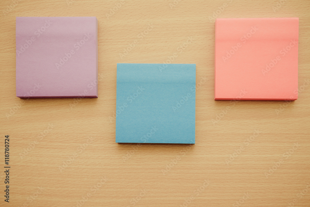 Color block of paper notes on wooden table background. Color block of paper notes on wooden table background.