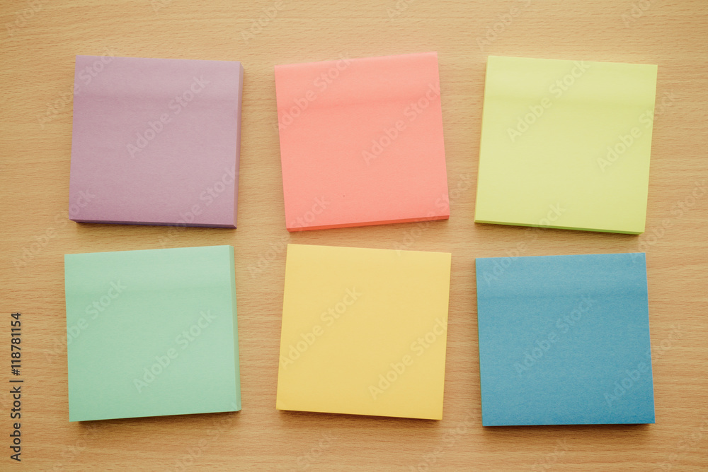 Color block of paper notes on wooden background Color block of paper notes on wooden background