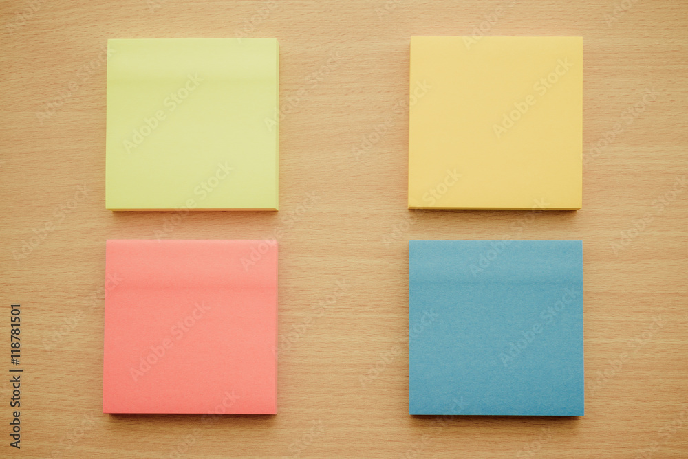 Color block of paper notes on wooden table background. Color block of paper notes on wooden table background.